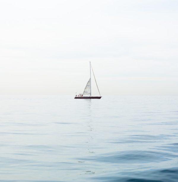 A sailboat drifting on a calm sea